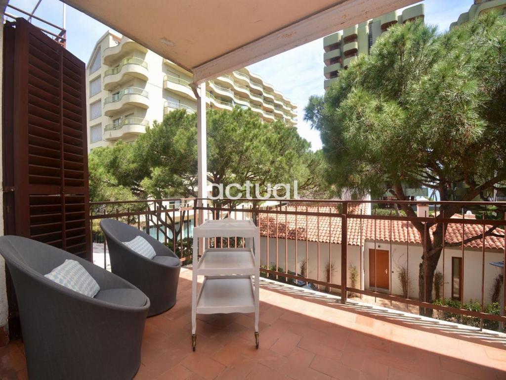 a patio with two chairs and a table on a balcony at CARLE MAGNE ESC 3 in Platja d'Aro