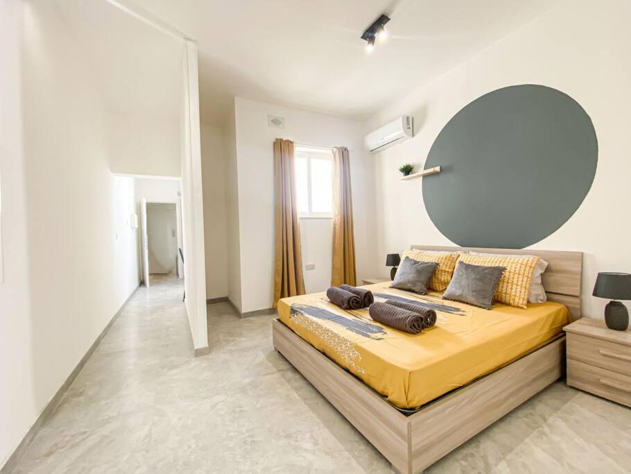 a bedroom with a large bed with a large mirror at 1 Bedroom Penthouse in Gzira in Il-Gżira