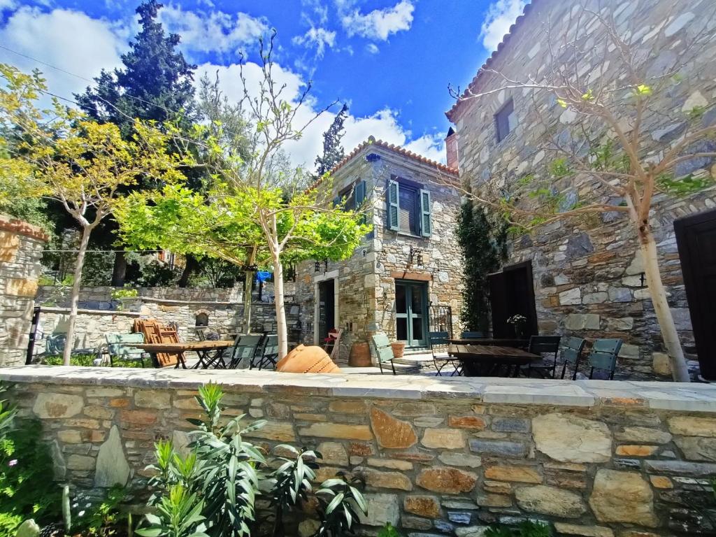 an exterior view of a stone house with a stone wall at Puli Stone Houses in Doğanbey