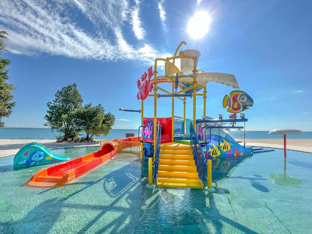 a water park with a colorful water slide at GRIFID Moko Beach - 24 Hours Ultra All Inclusive & Private Beach in Golden Sands