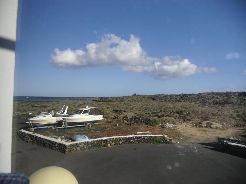 a view of two boats sitting on a dock at Tranquilo y Acogedor Apartamento in Órzola
