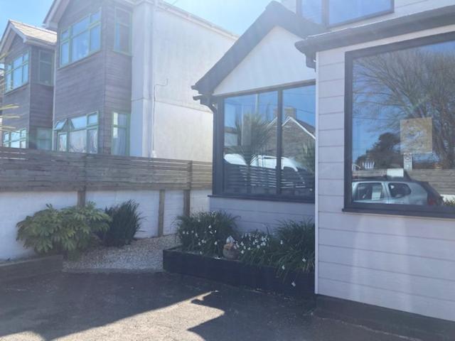 a house with a car in the window of it at The Salt Box- Lovely refurbished annexe, free parking, walk to Porth beach. in Saint Columb Minor