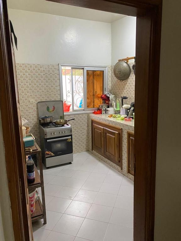 a kitchen with a stove and a counter top at silla in Mbour