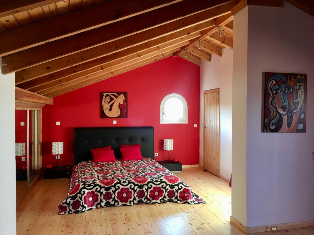 a bedroom with red walls and a bed with red pillows at Villa Mariza in Corfu Town