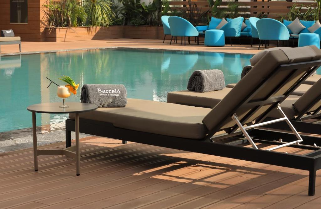 a bed sitting next to a swimming pool at Barceló Anfa Casablanca in Casablanca