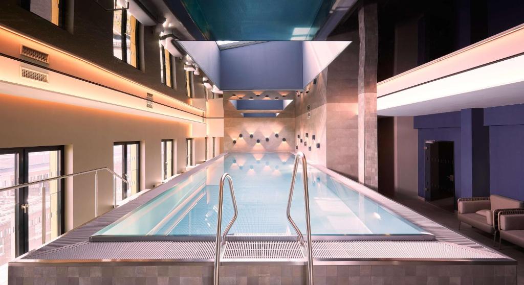 an indoor swimming pool in a building at Adina Apartment Hotel Dusseldorf in Düsseldorf