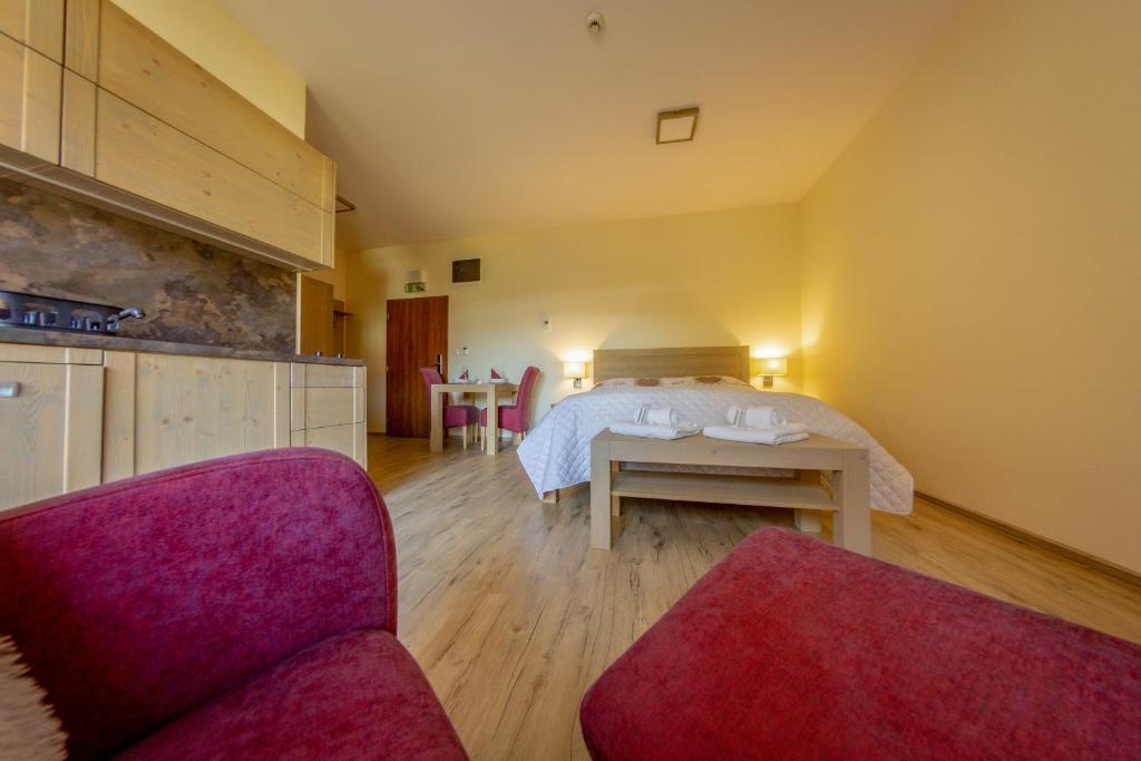 A bed or beds in a room at Apartmány Tatry