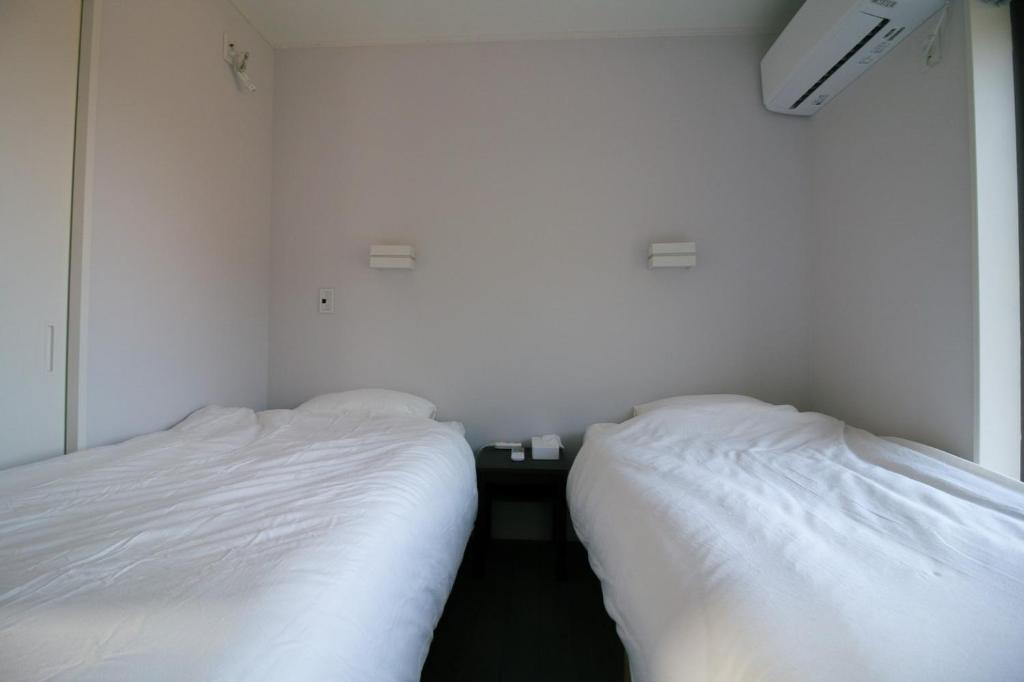 Postel nebo postele na pokoji v ubytování 1日1組限定貸切宿 Kitohana YUYA