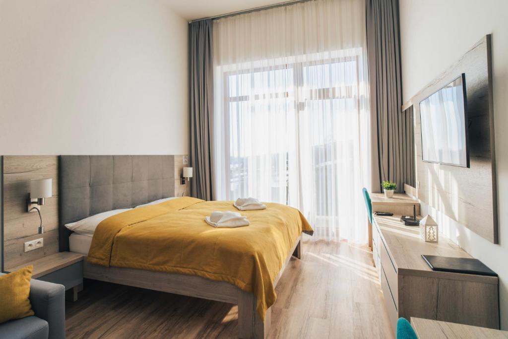 A bed or beds in a room at Apartmány Tatry