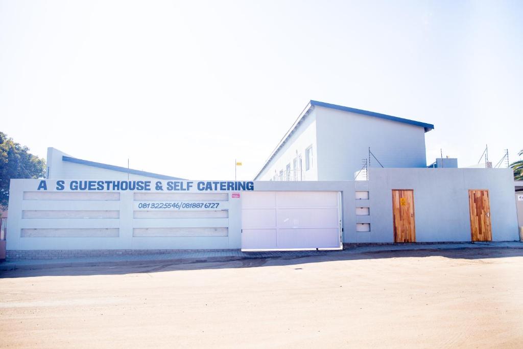 a white building with a sign that reads a s guest house and self catering at AS Guesthouse & Self-catering in Swakopmund