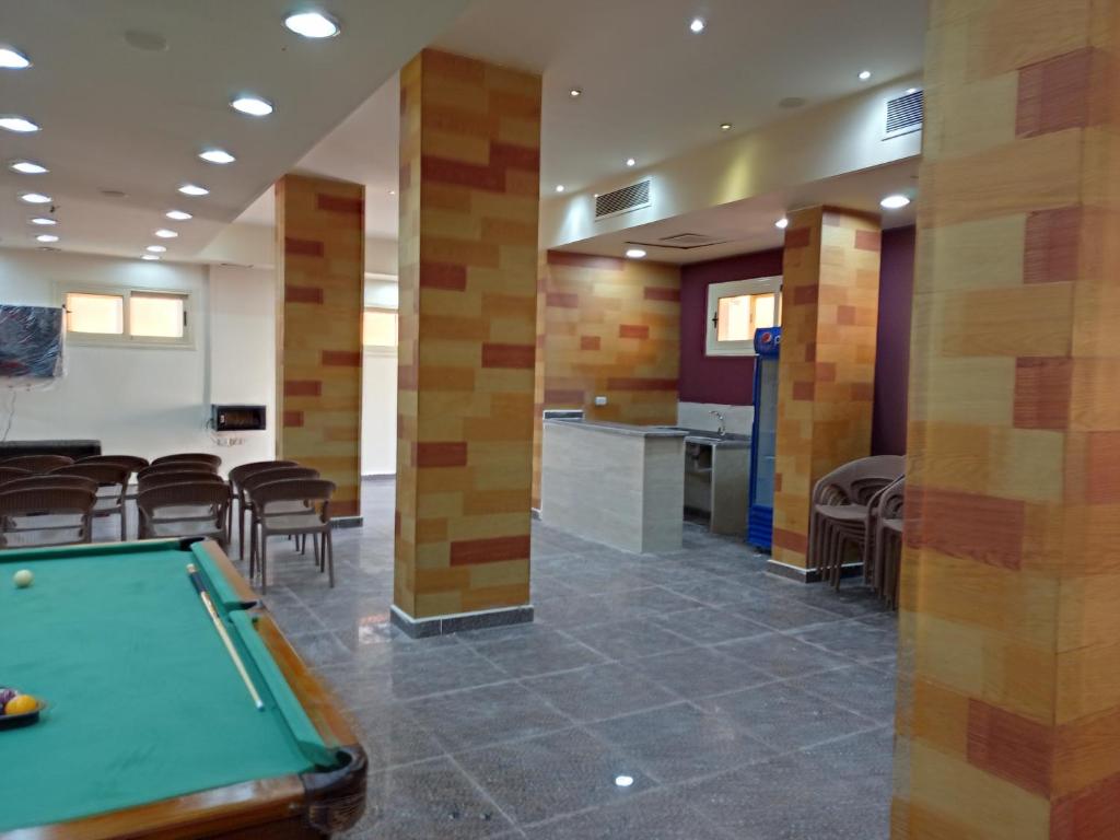 a pool table in a room with chairs at La Sirena Hotel & Resort - Families only in Ain Sokhna