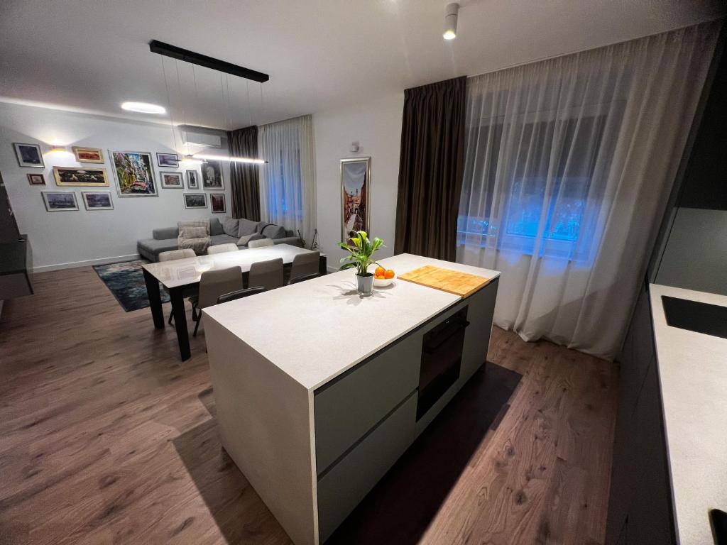 a kitchen and living room with tables and chairs at Luxury home beach apartament in Split, Croatia in Split