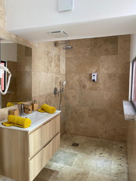a bathroom with a sink and a shower at Casa di Floumy in Calvi