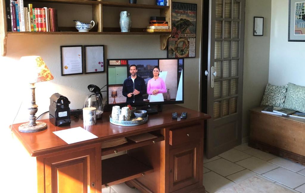 a desk with two monitors on top of it at Maison Lamothe in Flamarens