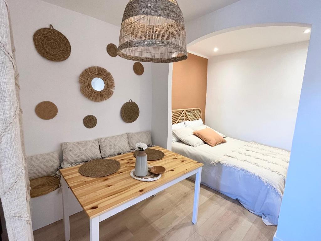 um pequeno quarto com uma mesa e uma cama em Studio Pampa - Centre historique - Climatisation - WiFi em Grasse