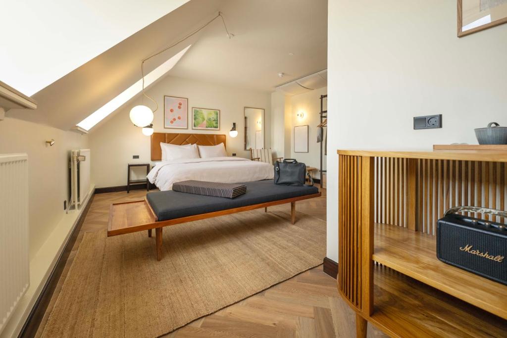a large bedroom with a bed and a staircase at Hotel Mayfair in Copenhagen