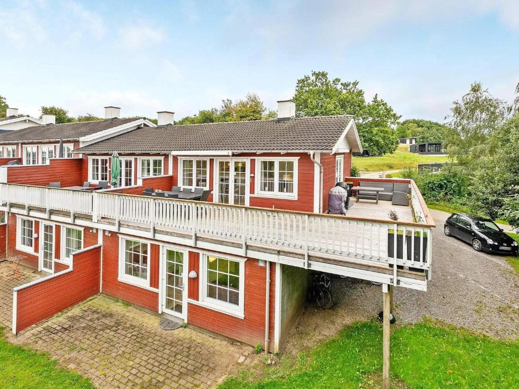 an aerial view of a red house with a deck at Holiday home Aabenraa LXIX in Aabenraa