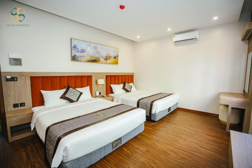a hotel room with two beds in it at Ha Long Seasun Hotel in Ha Long