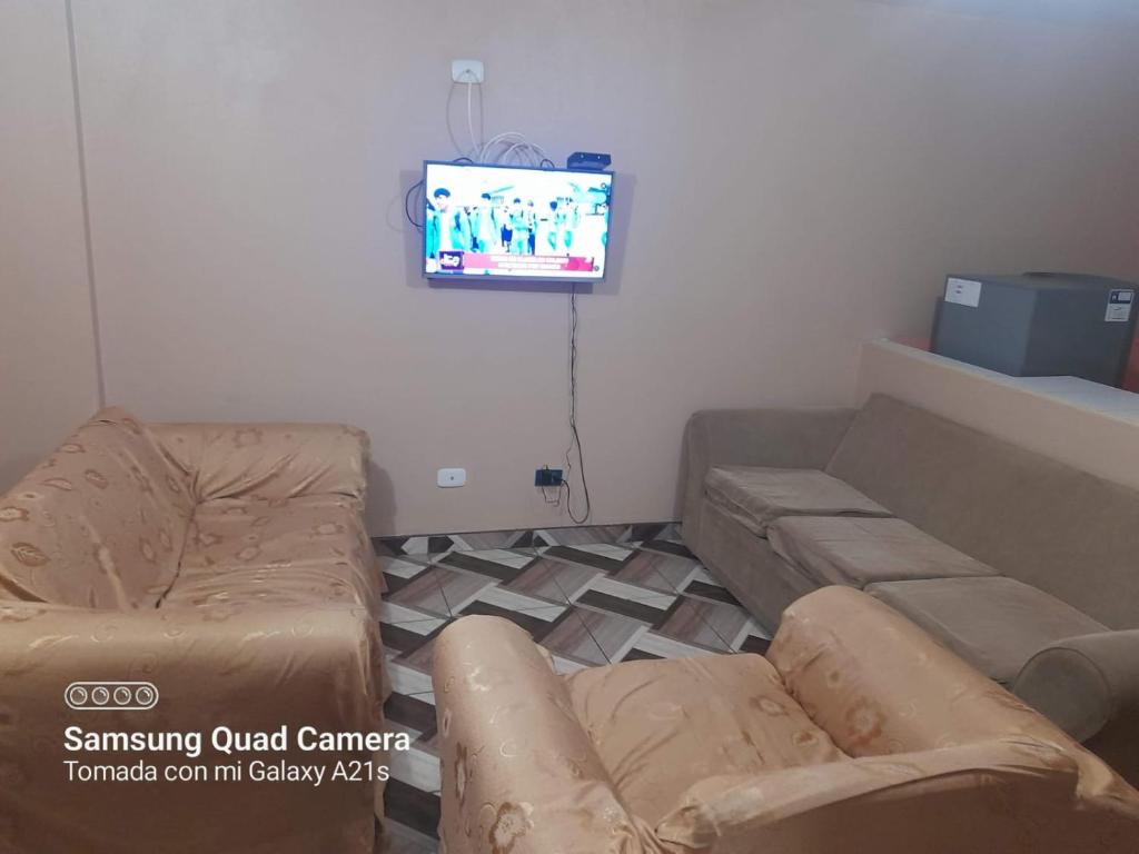 a living room with a couch and a tv at Kely2 Tercer Piso in Lima