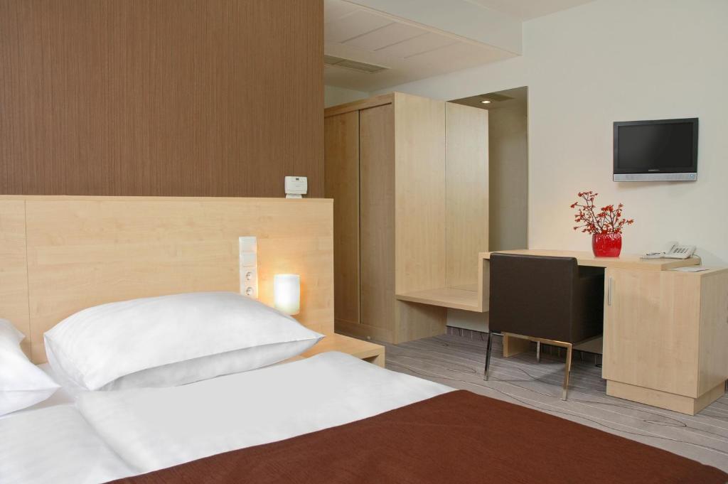 Posteľ alebo postele v izbe v ubytovaní Promenade City Hotel
