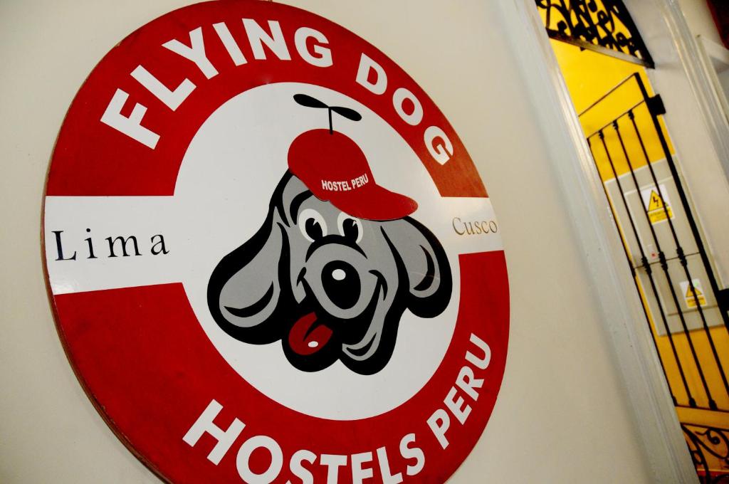 a sign for a hong kong dog hospital at Flying Dog Hostel in Lima