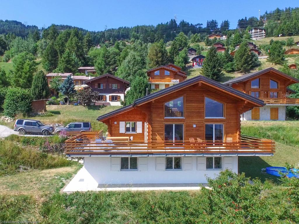 a house on top of a house on a hill at Chalet le Fauconnier in La Tzoumaz
