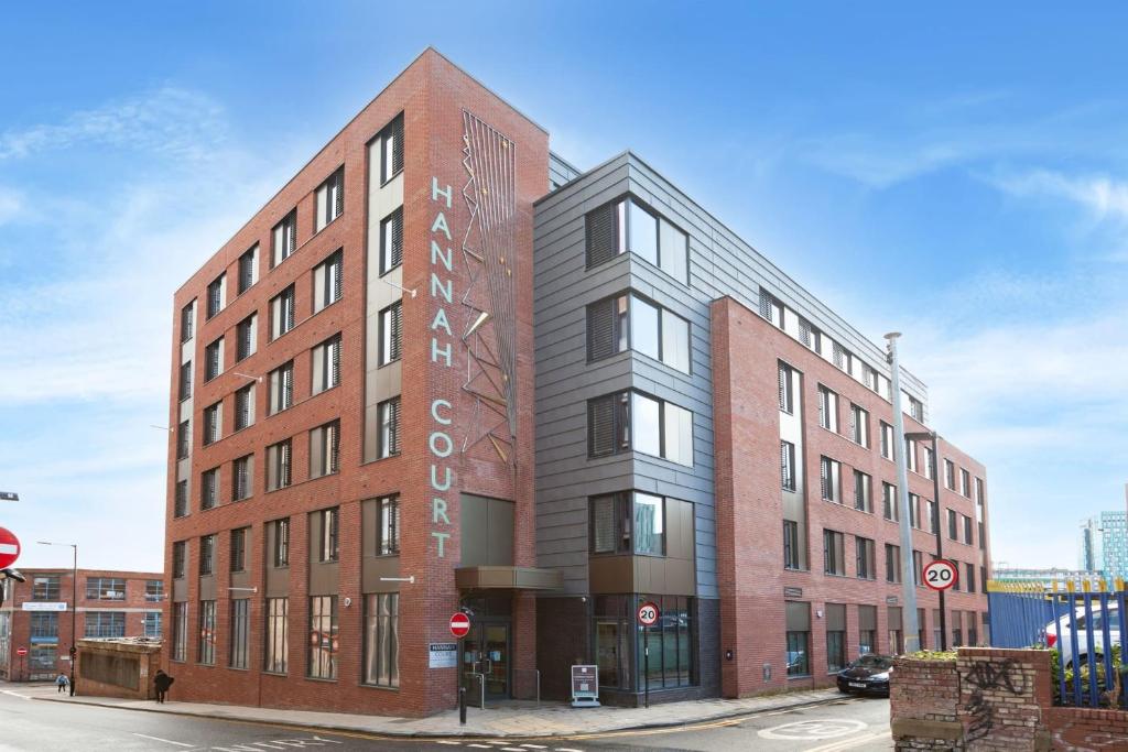 a brick building with a sign on the side of it at For Students Only City Living Modern Studios at Hannah Court in Sheffield in Sheffield