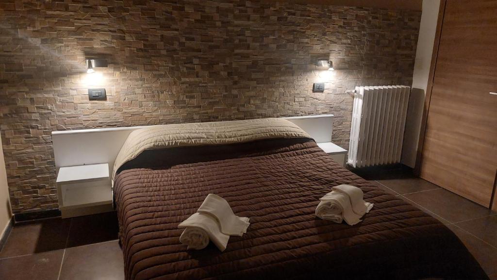 a bedroom with a bed with towels on it at Hotel La Torre in Formigine