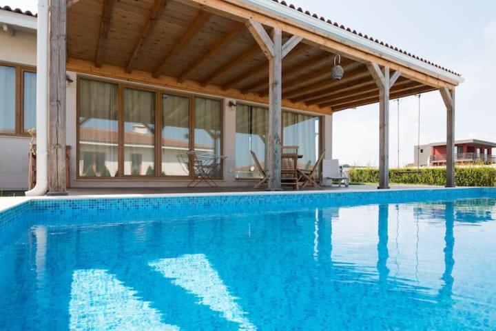 a swimming pool with a pavilion and a house at Villa Shelly whith private pool in Lozenets