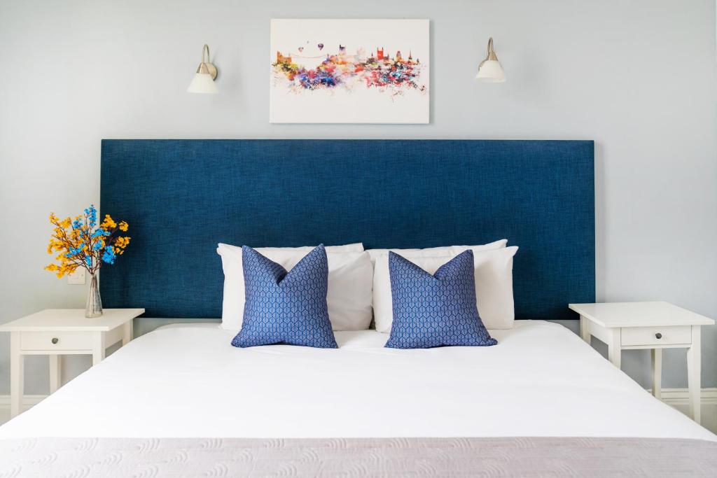 a bedroom with a large bed with a blue headboard at The Washington in Bristol