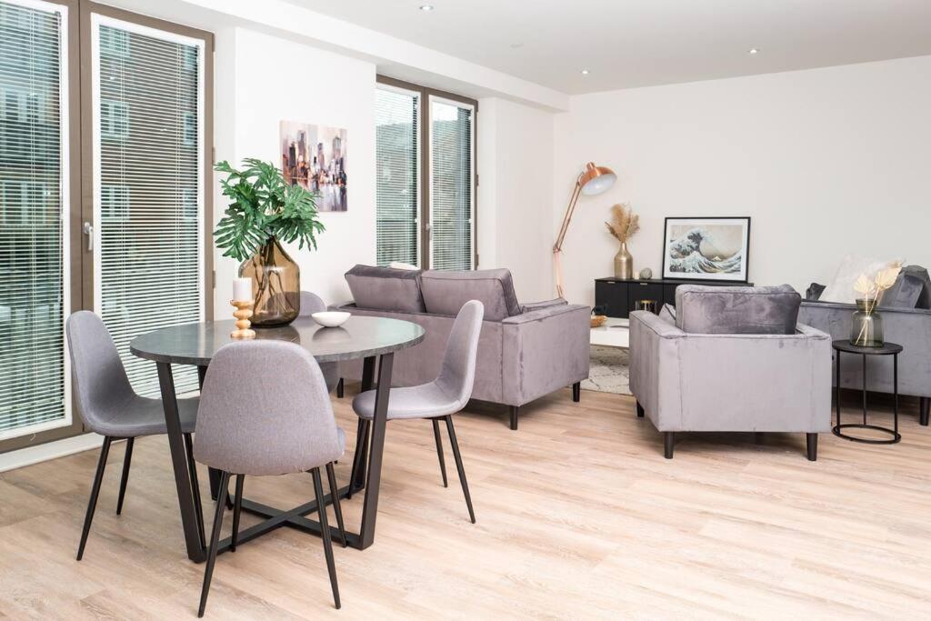 a living room with a table and chairs at Luxury Free Parking Townhouse in Manchester