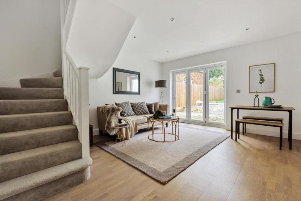 a living room with a staircase and a piano at Amazing 3 Bed Interior Designed House with Garden - 114 The Hervey in London