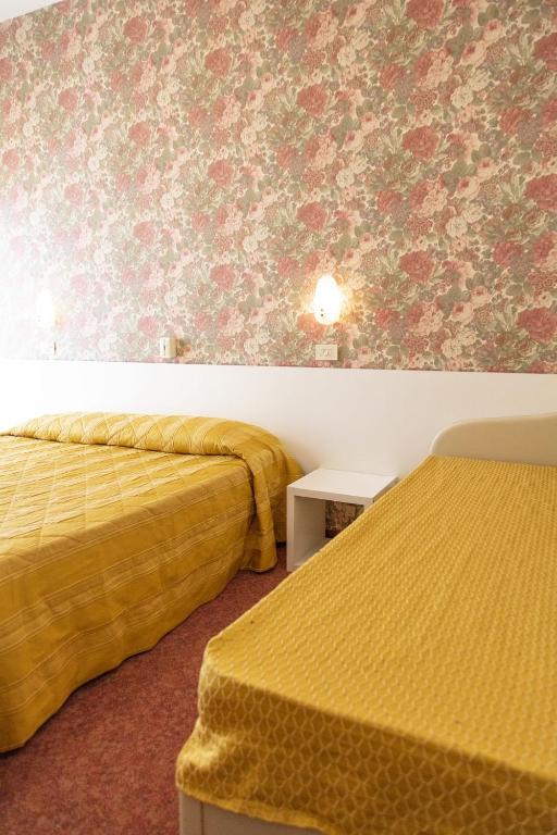 Postel nebo postele na pokoji v ubytování Hotel Igea Spiaggia