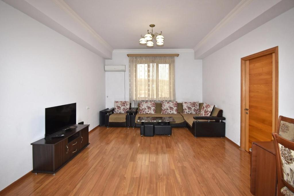 a living room with a couch and a tv at Argishti Street, 2 bedrooms Comfortable apartment GL152 in Yerevan