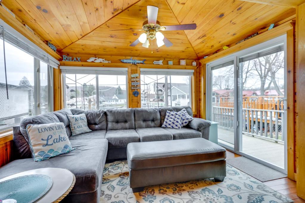 a living room with a couch and a ceiling fan at Lime Lake Cottage with Lakefront Deck and Dock! 