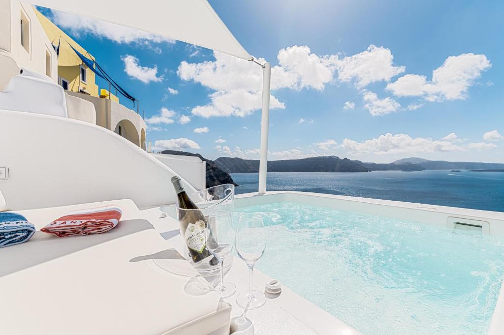 a swimming pool with a view of the ocean at Aristos Life Luxury Cave Villas in Oia