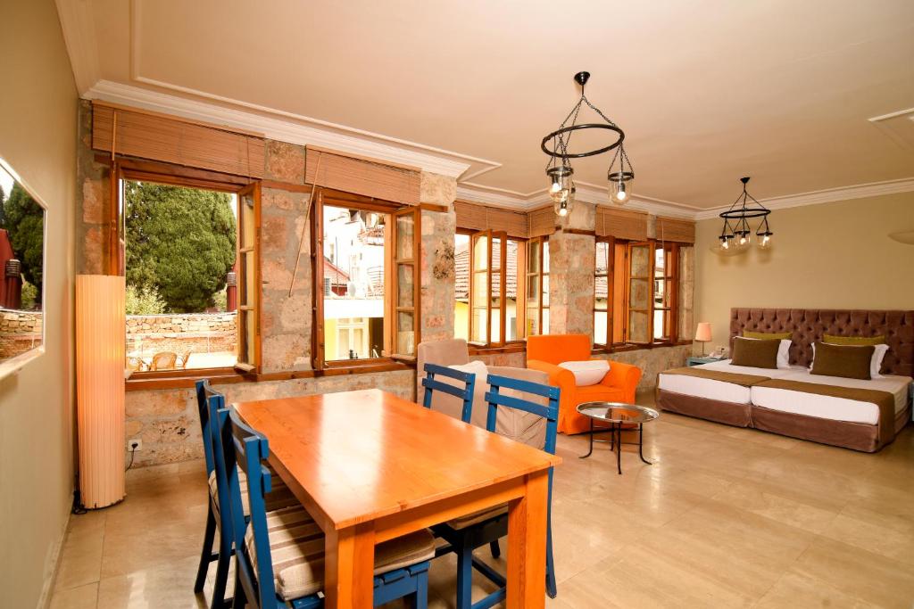 a living room with a table and chairs and a couch at Gorgeous Flat near Hadrian's Gate in Antalya