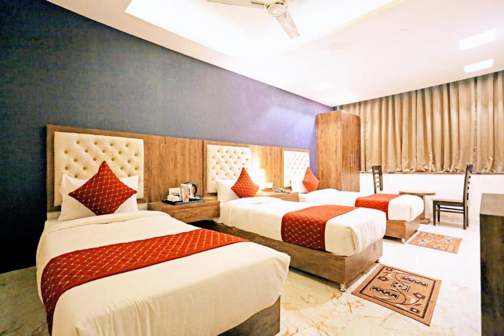 a hotel room with two beds with red and white at Mayda Inn- A Boutique Hotel in New Delhi