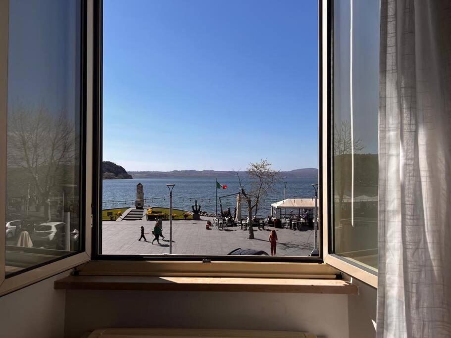 a window with a view of a street and the water at Principessa Iolanda, Vista lago, Panoramico, 4 posti letto in Anguillara Sabazia