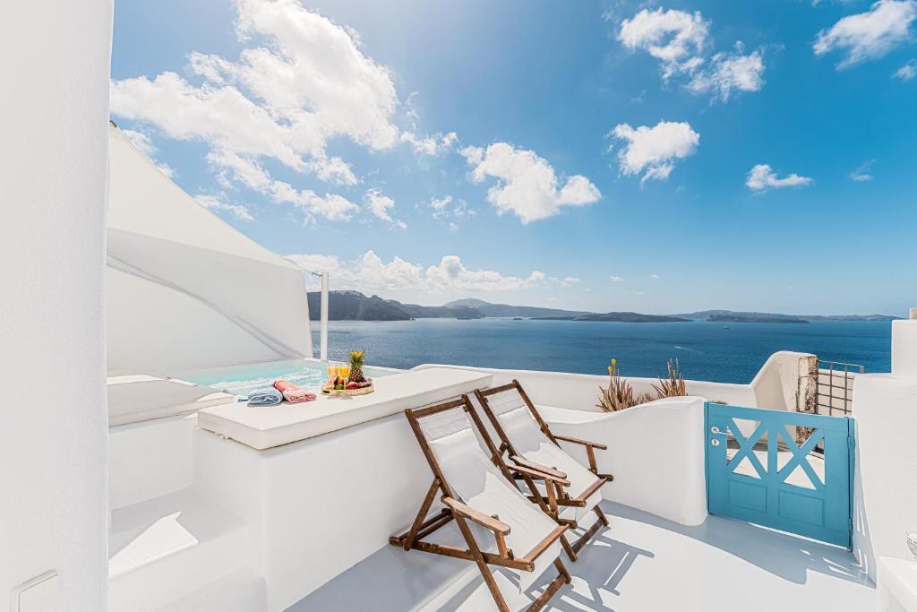 a view of the ocean from the balcony of a house at Aristos Life Luxury Cave Villas in Oia