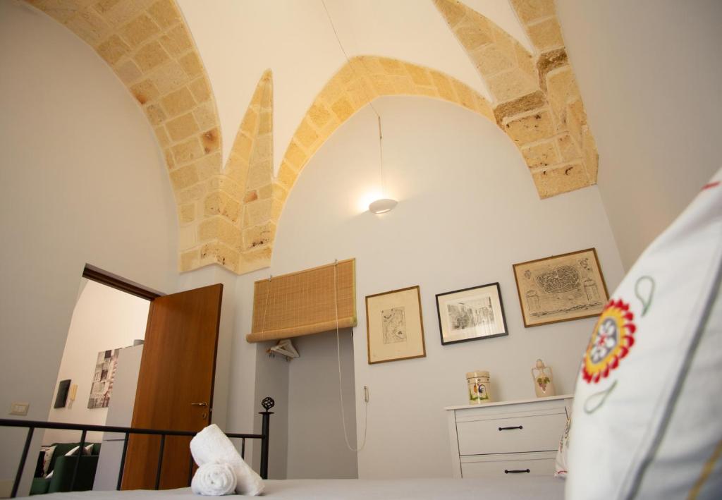 a bedroom with arches on the wall and a bed at Sogni a Sud - The Fab Stay in Mesagne