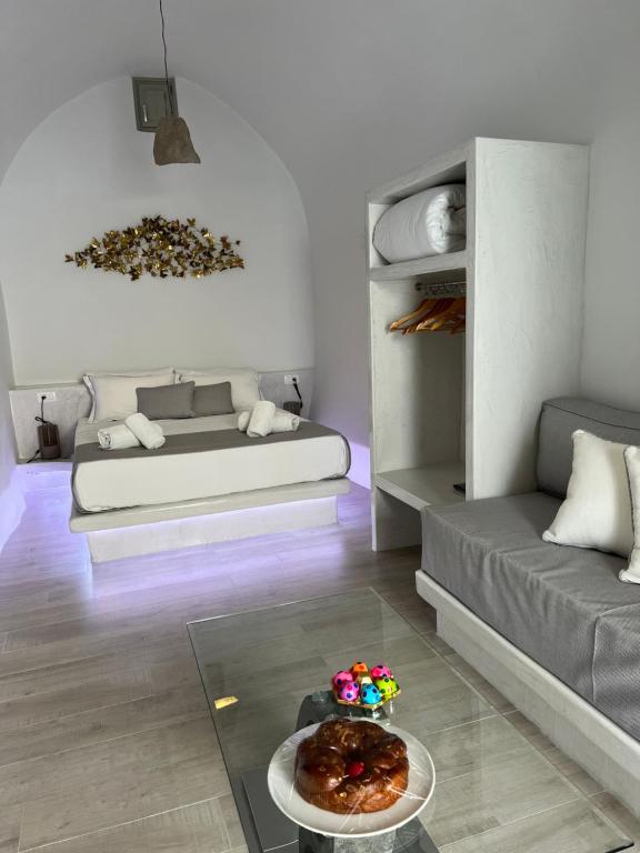 a living room with a bed and a table with food on it at Lamar Cave house in Emporio Santorini