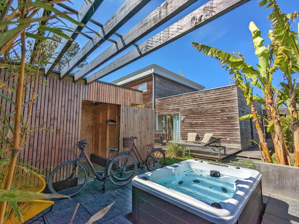 a hot tub in the backyard of a house at Fare Bambou in Gujan-Mestras