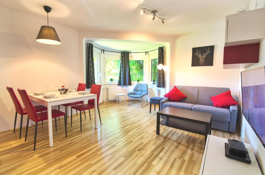 a living room with a couch and a table at Mozart Top 1 - by Alpen Apartments in Zell am See