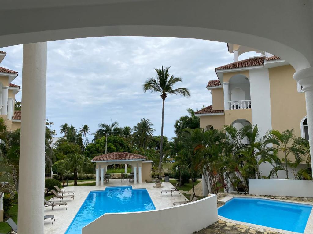 a view of the pool at a resort at Picturesque Ocean View Condo in San Felipe de Puerto Plata