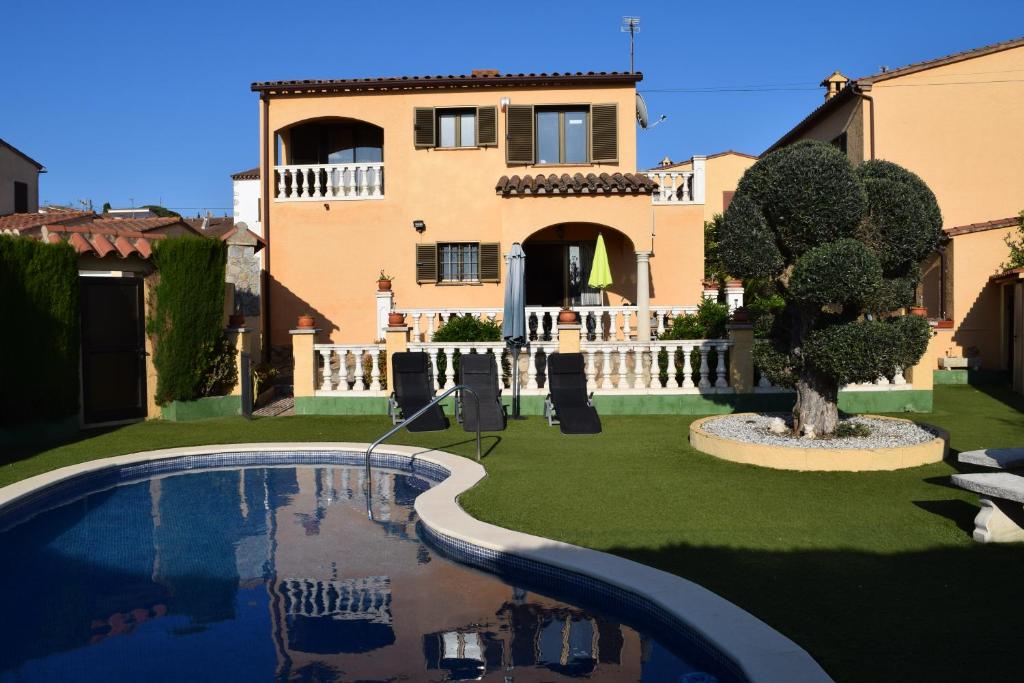 a villa with a swimming pool in front of a house at Casa L'Escala 31 in L'Escala