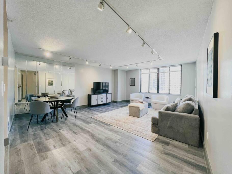 a living room with a couch and a dining room at The Hartford Skyline Downtown Hartford XL Center in Hartford