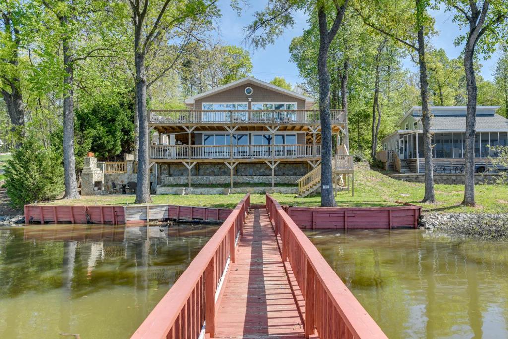 a large house with a bridge over a river with a house at Pet-Friendly Lexington Vacation Rental on Lake! in Lexington