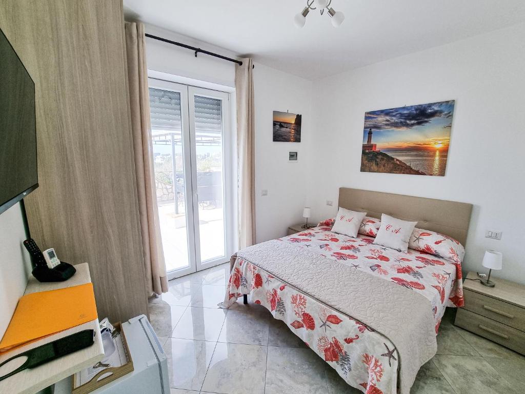 a bedroom with a bed and a large window at Casa Astra in Anacapri