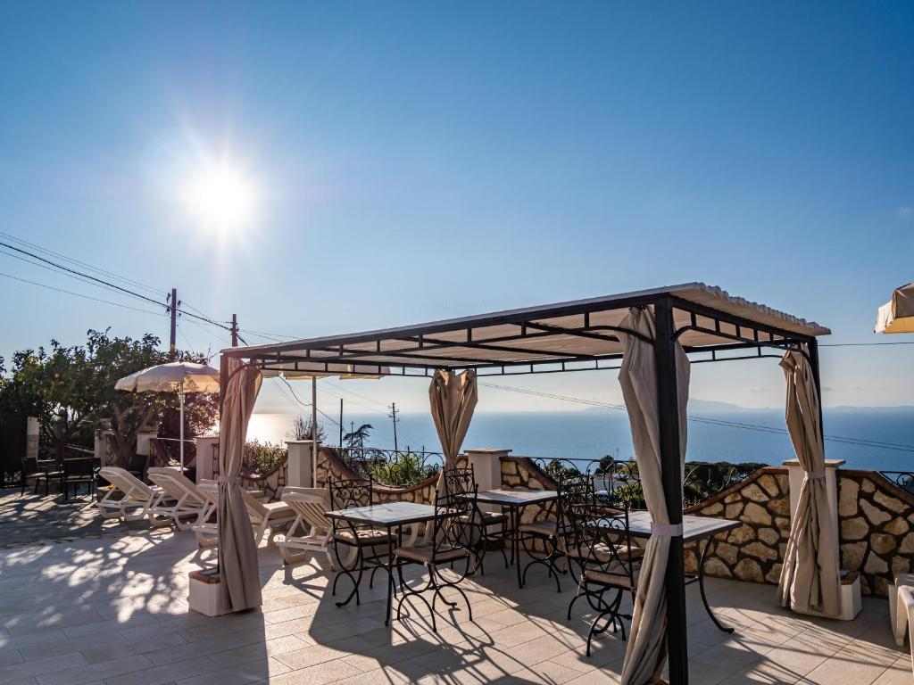 a patio with tables and chairs under a canopy at Casa Astra in Anacapri